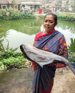 Mrs. Arati Barman with a large catla from her farm.